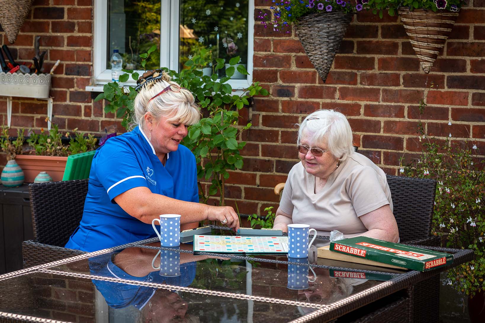 Carer and client playing scrabble